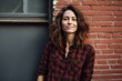 © CogniLens - Portrait of a glad woman in her 30s wearing a comfy flannel shirt against a vintage brick wall. AI Generation