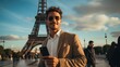 © visoot - Handsome tourist is standing in front of the Eiffel Tower.