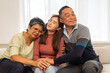 © Art_Photo - Portrait enjoy happy smiling love asian family.Senior mature father hug with elderly mother and young adult woman play laughing and having fun together at home.insurance concept