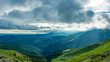 © Alexandru V - Sun shines through stormy clouds above Parang mountains. A dramatic sky can be seen as sun rays are penetrating the rainy clouds. Carpathian Massif, Romania.