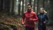 Side by side, two runners, one in a striking red jacket and the other in blue, stride through a misty forest trail, a picture of health and companionship.