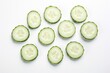 Sliced Cucumber Isolated on White Background. Freshly Chopped Cucumber Slices in Heap with Topview of Whole Cucumber Piece