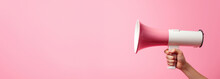 Arm Extended Holding A Pink Megaphone Against A Pink Backdrop