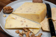 © barmalini - Piece of Dutch Gouda cheese made from cow milk with added walnuts close up