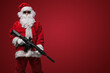 © Fxquadro - A man dressed as Santa Claus, wearing sleek black sunglasses, poses with toy machine guns against a bold red backdrop