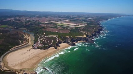 Wall Mural - Aerial video filming by drone of the sea bay and beach near the village of Odeceixe Alentejo Portugal. View of the Alentejo region