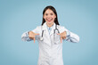 © Prostock-studio - Excited female doctor pointing downwards