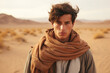 © vvalentine - Portrait of a young guy in a scarf in the middle of the desert, generative ai