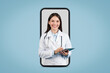 © Prostock-studio - Female doctor with tablet in huge phone screen