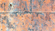 Industrial grunge rusty metal background texture with faded yellow and red paint 