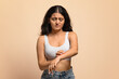 © Prostock-studio - Skin Disorders. Young indian woman suffering eczema, scratching irritated skin on arm