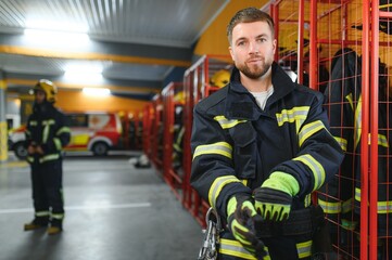 Wall Mural - A firefighter puts on a fire uniform at the fire department