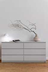 Wall Mural - Gray minimalistic commode with decorative elements on top