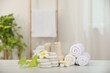 Composition with different spa products and plumeria flowers on white marble table indoors, space for text