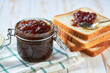 Delicious figs jam on table close-up. Slices Bread and figs jam on wooden table.