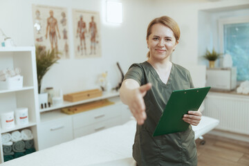 Poster - happy massage therapist woman in massage cabinet with clipboard