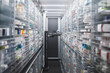 Narrow pharmacy aisle flanked by towering shelves stocked with medicine boxes. A pharmacy robot navigates through, ensuring efficient and precise medication retrieval.
