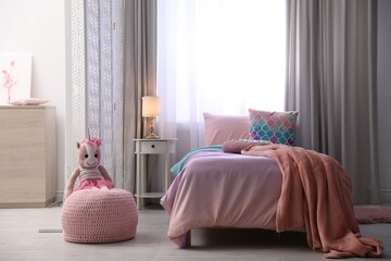 Poster - Bed with beautiful linens in children's room. Modern interior design