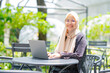 © maya1313 - Cheerful muslim lady in hijab working online at cafe, using laptop, copy space. Side view of smiling arab woman freelancer typing on laptop, enjoying her distant job, Muslim working woman concept.