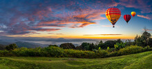 Panoramic View. Colorful Hot-air Balloons Flying Over The Mountain With Sea Fog, Mist And Red Clouds In Blue Sky Morning. Sport, Travel And Tourism. Balloons Over Huai Nam Dang National Park, Thailand