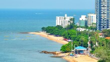 Jomtien Beach, A Lively Hotspot, Where Beach Bars, Colorful Umbrellas, And Bustling Street Vendors Create A Vibrant Atmosphere. Day Or Night, It's A Hub Of Energy And Entertainment. Thailand. Drone.
