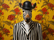 A zebra wearing a stripped suit and a hat