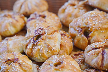 Wall Mural - Puff pastry samosa with meat filling and sesame seeds.