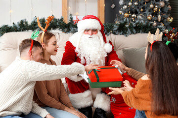 Sticker - Santa Claus giving Christmas gift to young people at party