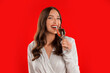 canvas print picture - Joyful elegant woman enjoying taste of champagne on red background