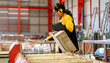 © Nassorn - Industrial engineer in safety jacket working in heavy metal engineering factory. Confident Latin technician inspector woman worker check product quality in metalwork steel manufacturing facility.