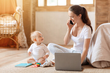 young mother businesswoman working from home, take care of baby