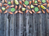 Fototapeta Kuchnia - Delicious shrimp with lime and citrus. Wooden background.