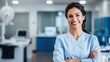 © CStock - Smiling female dentist standing with his arms folded in front of the dentist's office.