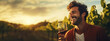 © AngrySun - Portrait of a smiling man with a glass of wine, blurred backdrop of vineyard on a sunset. Generative AI