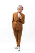 © NVB Stocker - golden brown business suit. Fashion portrait Asian young man. model, clothing and cosmetics. Young male model blond hair in fashionable clothing isolated on white background