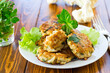 cooked vegetarian fried cauliflower cutlets, in a plate .