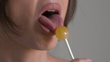 Close-up of woman's tongue licking lollipop