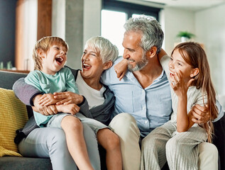 Wall Mural - grandchild family child grandparent grandfather happy together grandmother girl senior boy man woman smiling granddaughter grandson sofa