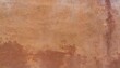 abstract background of an exterior reddish brown adobe style textured wall surface