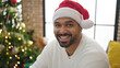© Krakenimages.com - African american man celebrating christmas smiling at home