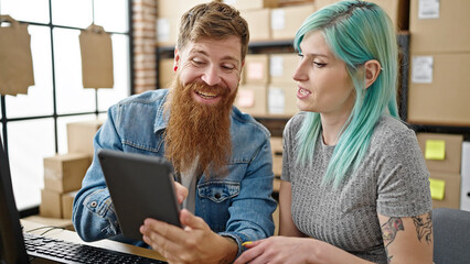 Wall Mural - Man and woman ecommerce business workers using touchpad sitting on table at office