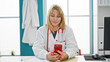© Krakenimages.com - Young blonde woman doctor using smartphone working at clinic