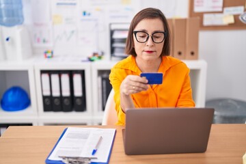 Sticker - Middle age woman business worker using laptop and credit card at office