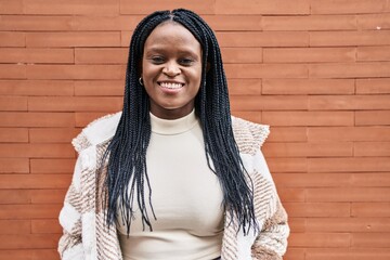 Sticker - African american woman smiling confident standing over isolated brick background