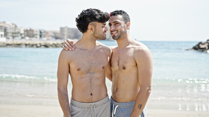 Wall Mural - Two men tourist couple smiling confident hugging each other at beach