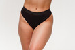© RAKOVSKIY - A woman with a beautiful feminine figure in black lingerie with overweight, cellulite and stretch marks.