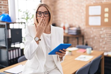 Sticker - Young caucasian woman working at the office wearing glasses shocked covering mouth with hands for mistake. secret concept.