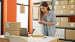 © Krakenimages.com - Young beautiful hispanic woman ecommerce business worker make photo to package at office