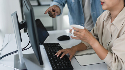 Two developer programmer discussing to checking code on monitor about programming to developing web