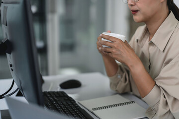 developer programmer drinking coffee and checking code on monitor for programming to developing web